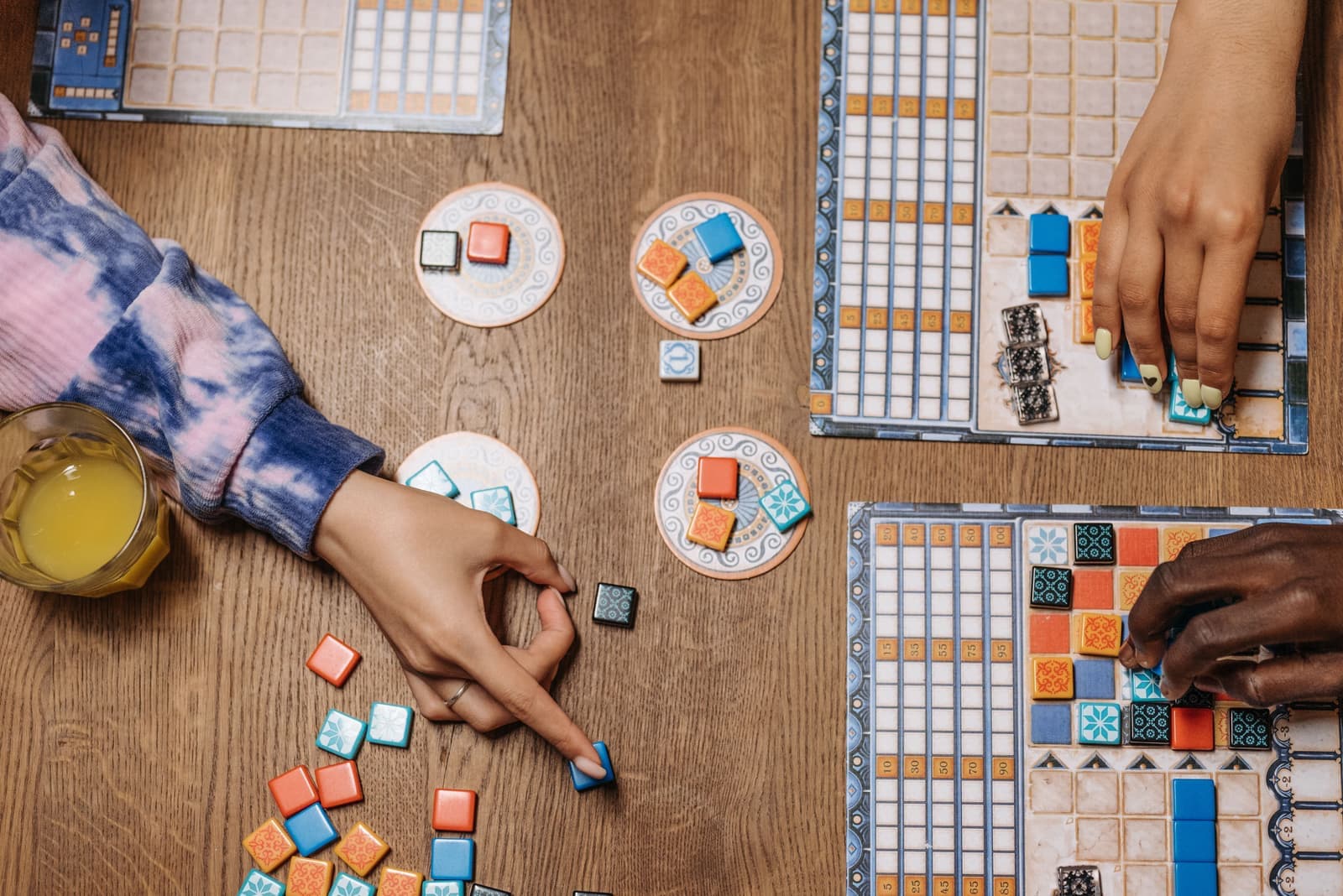 A small table set for two with a board game between the chairs